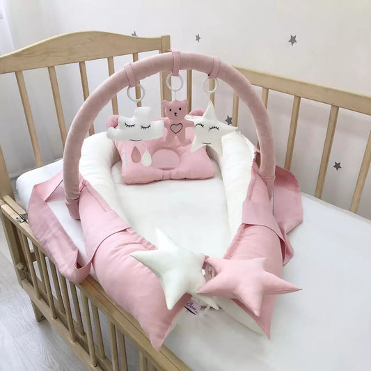 Dusty rose baby nest and arc with mini-toys - Baby Bedding Worlds